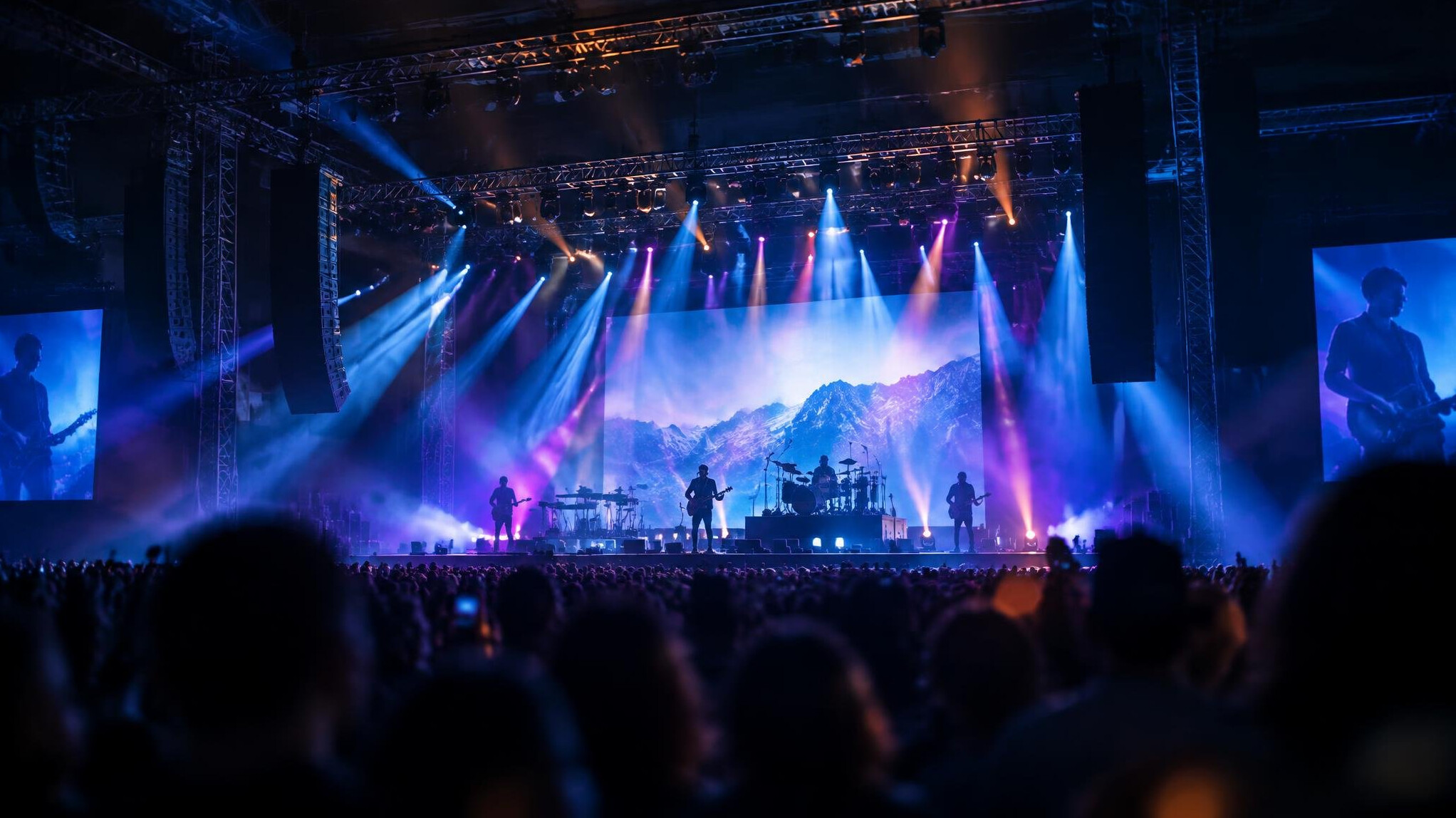 Live concert stage with lighting rigs and a crowd
